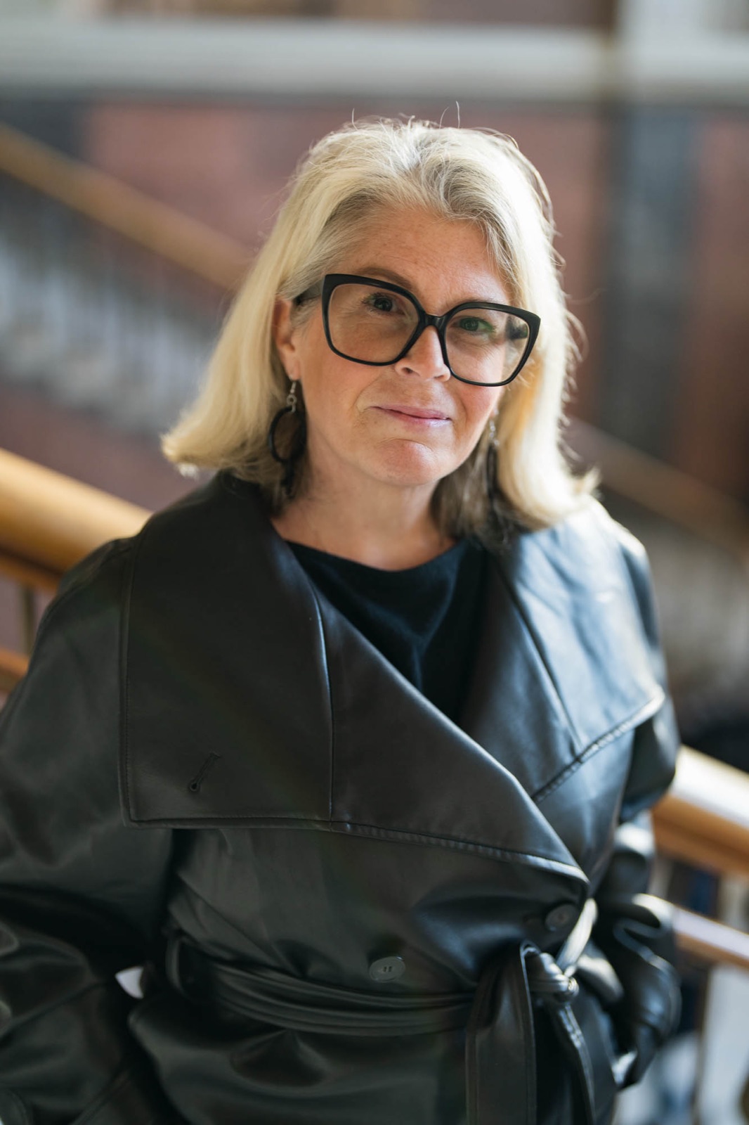 Portrait of Carina in a leather coat in a stairwell