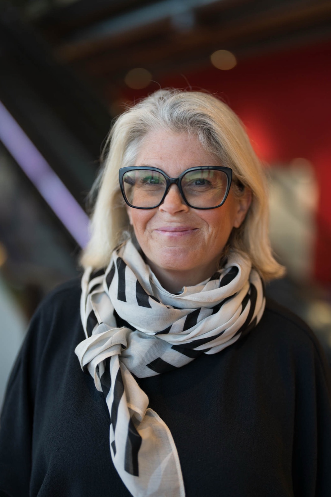 Carina smiling at the camera, patterned scarf